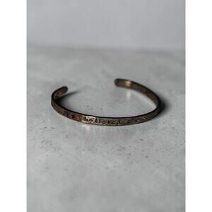 hand-stamped cuff bracelet featuring the inspirational phrase "She believed she